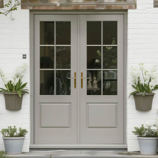 Image: A traditional French door with double glazing and a silver handle, installed in a white exterior door with a glass panel above the door.