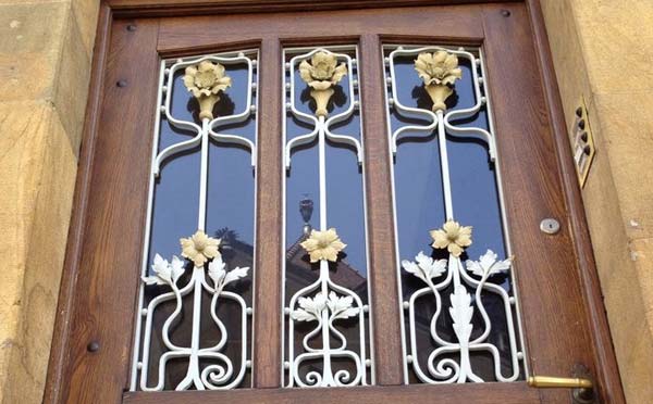 A quality wooden door with wrought iron work