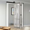 SpaceEasi Top Mounted Black Folding Track & Double Door - Eco-Urban® Bronx 4 Pane Solid Wood Door DD6315G - Clear Glass - Premium Primed Colour Options