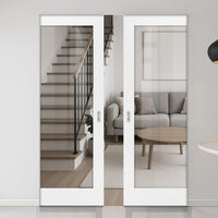 Modern interior with sliding glass doors opening to a living room and staircase.