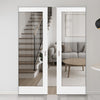 Modern interior with sliding glass doors opening to a living room and staircase.