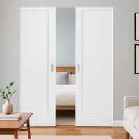 Modern interior with white sliding doors, wooden floor, and minimal decor.