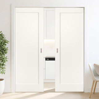 Image: Modern interior with white sliding doors, a plant, and a chair.