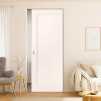 Modern interior design of a living room with a white door, gray armchair, and beige sofa.