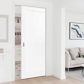Image: White sliding door in a modern interior setting with a sofa and artwork.