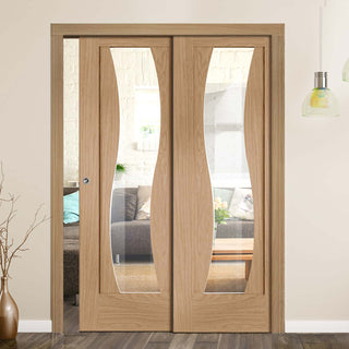 Image: Florence Oak Staffetta Twin Telescopic Pocket Doors - Clear Glass and Stepped Panel Design - Prefinished