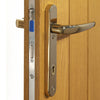 Image of a polished chrome door handle on oak door and the locking system