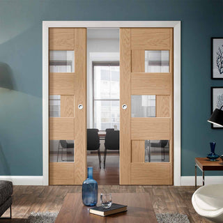 Image: Perugia Oak Panel Double Evokit Pocket Doors - Clear Glass - Prefinished
